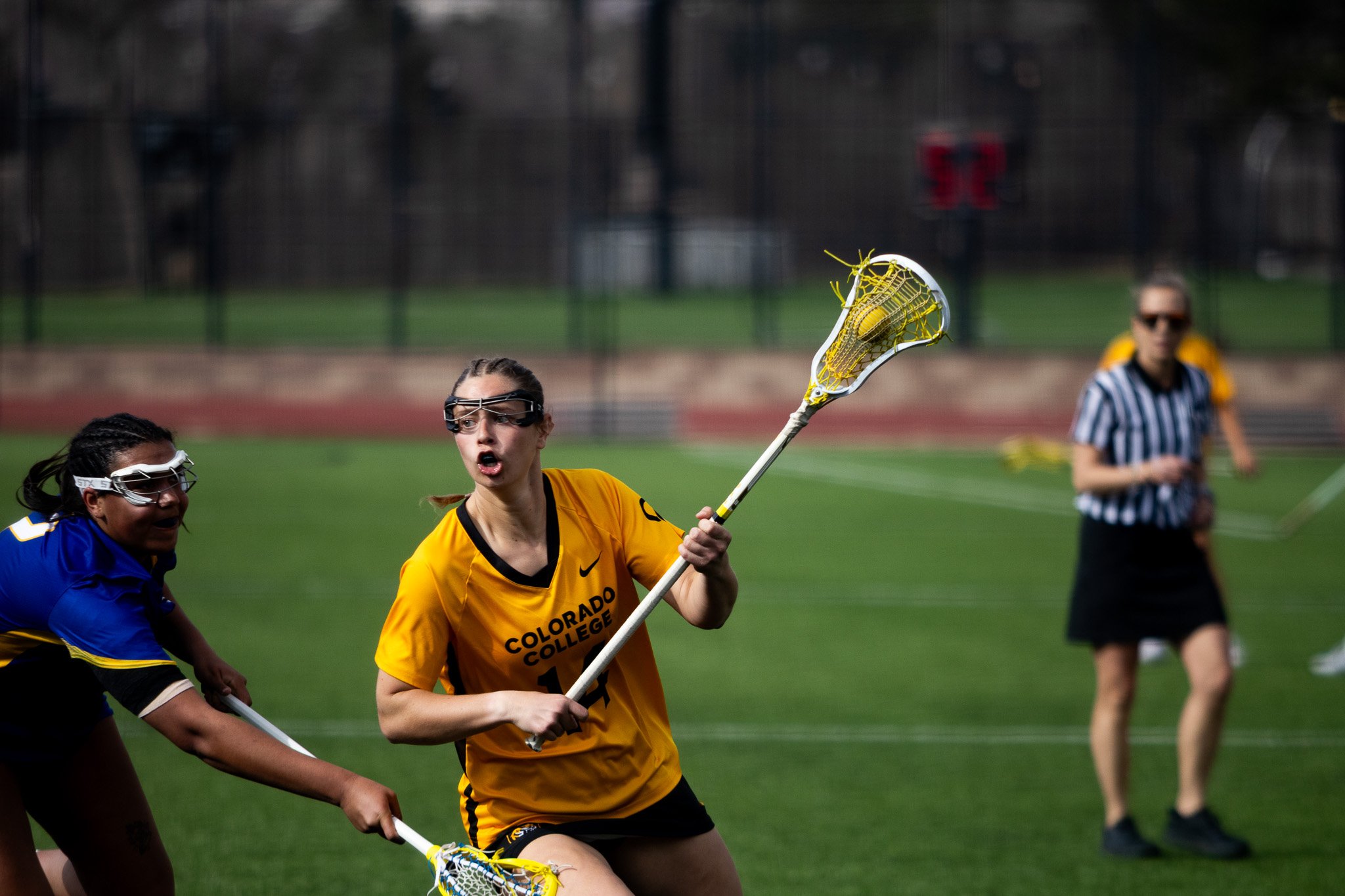 CC women's lacrosse player running with ball