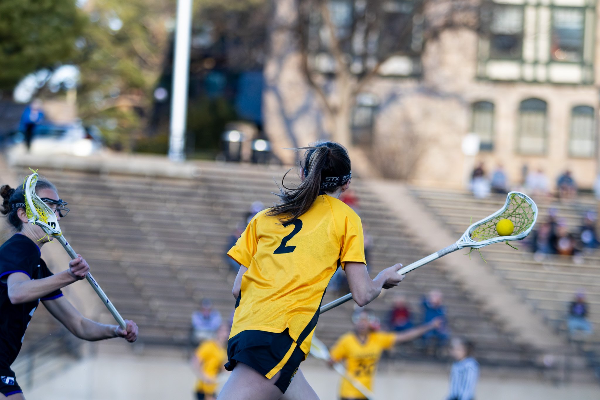 CC women's lacrosse player in motion