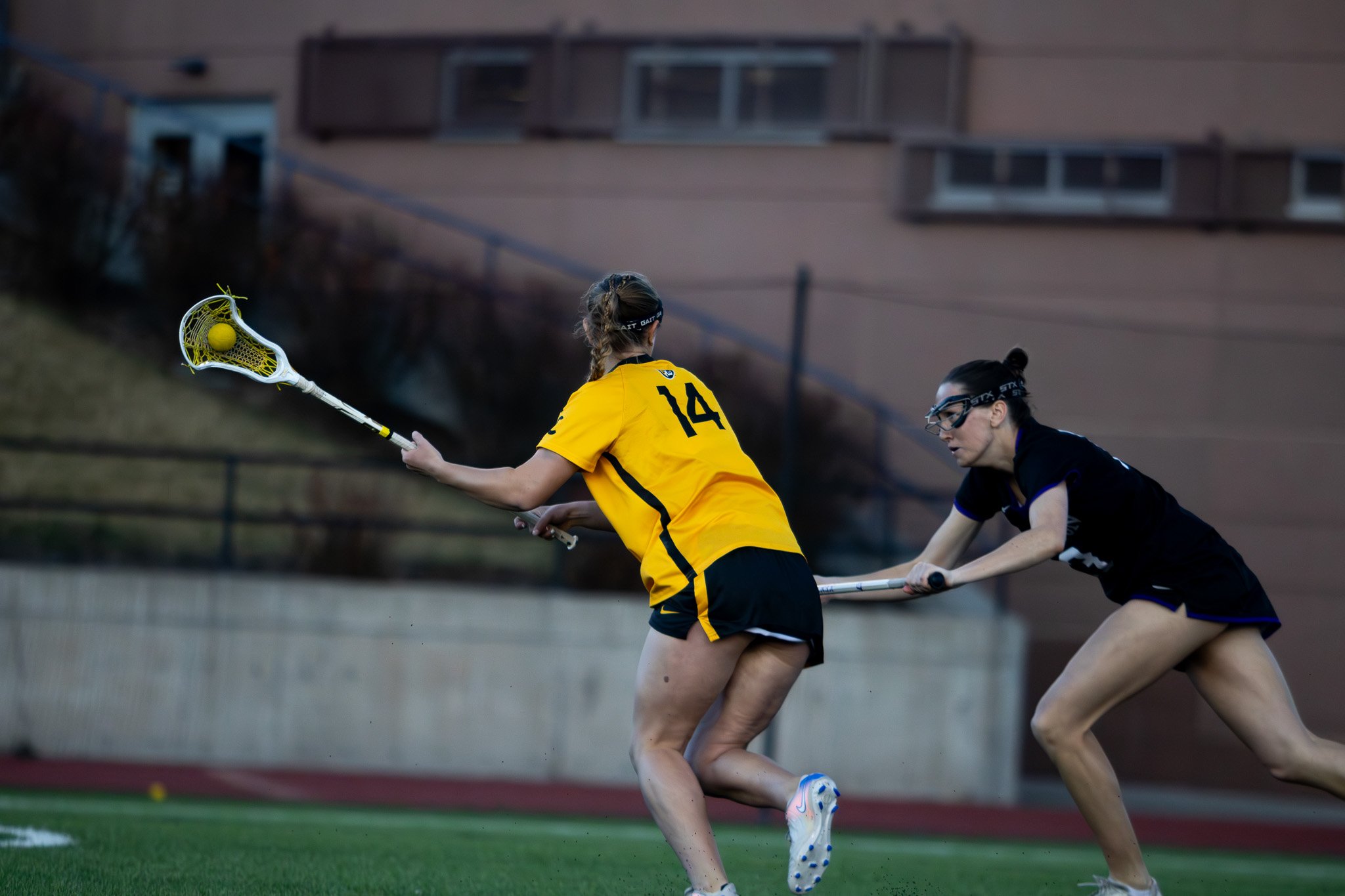 CC women's lacrosse player dodging defender