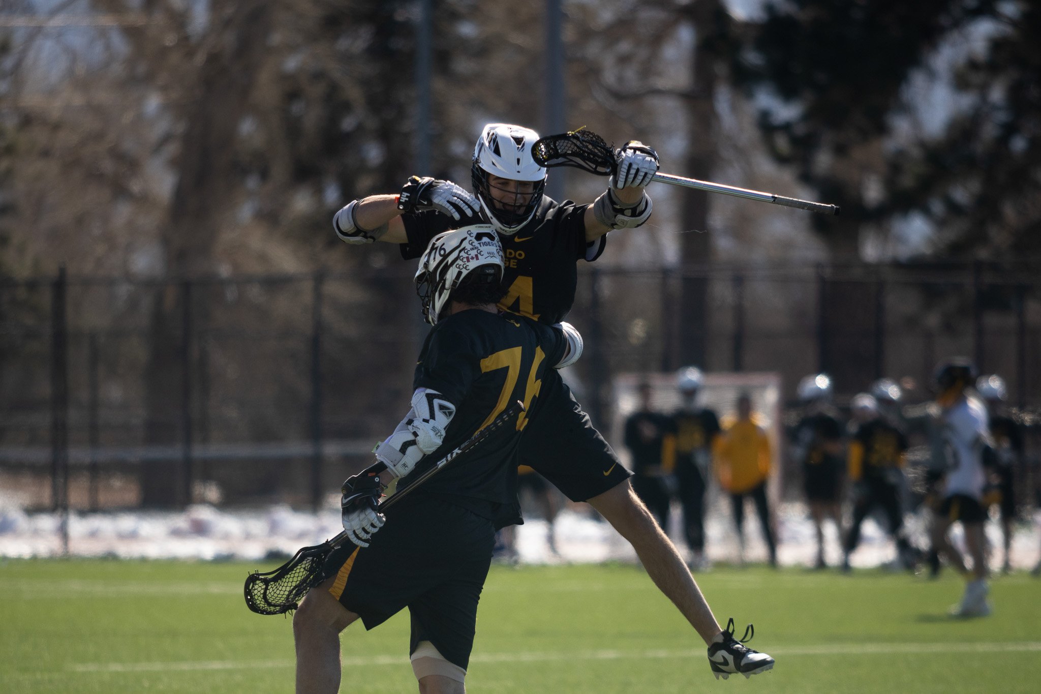 CC men's lacrosse player dodging defender