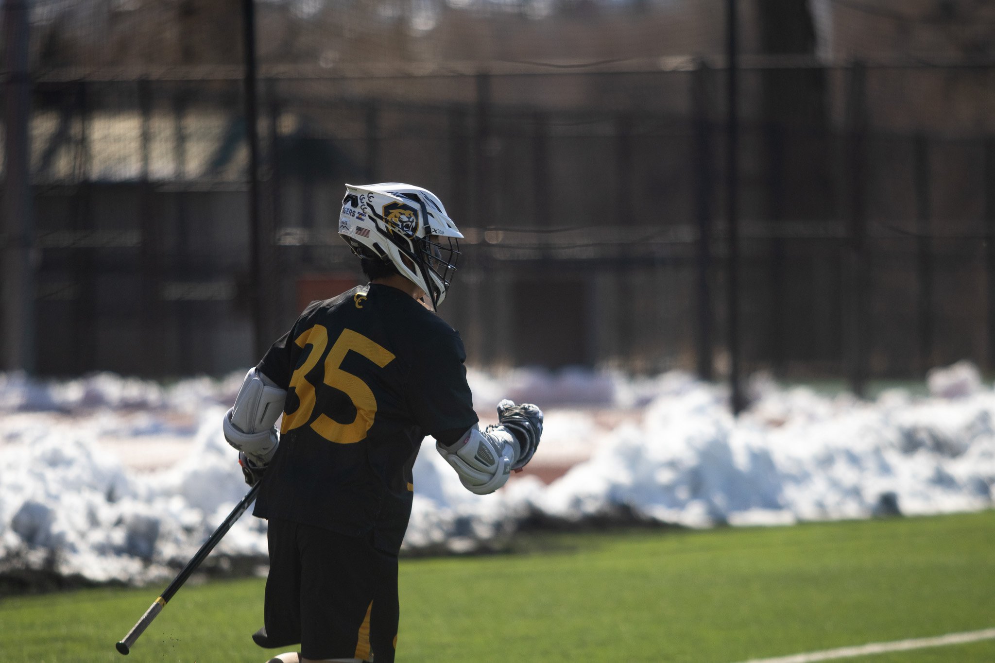 CC men's lacrosse player driving past opponent
